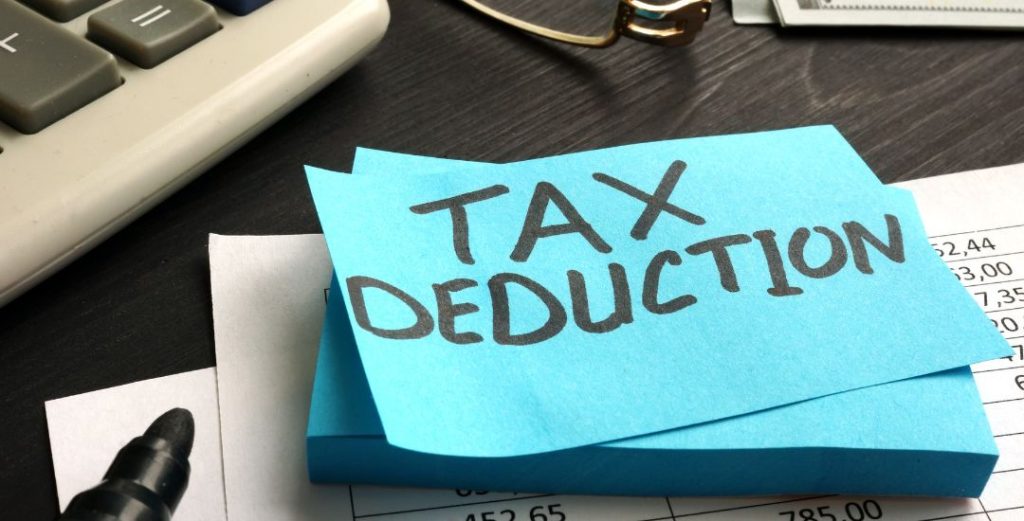 tax deduction on blue post-it on office desk
