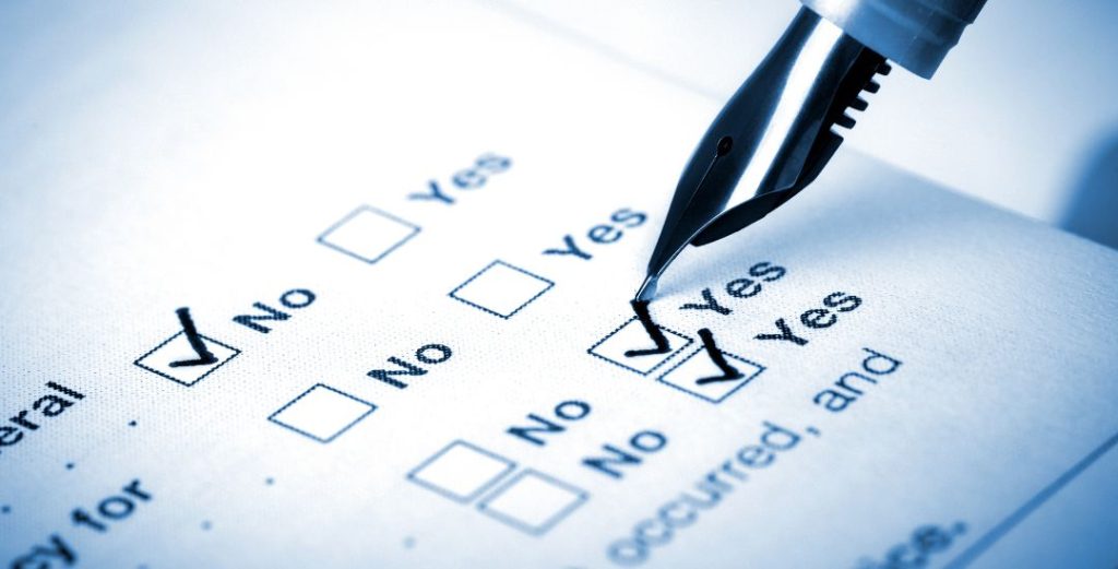 pen making checkmark on questionnaire