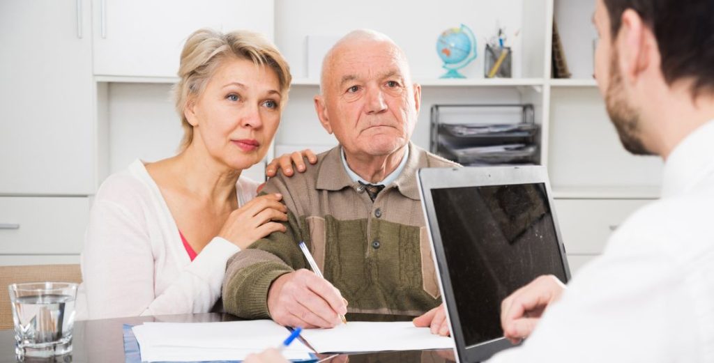elderly couple meeting with agent