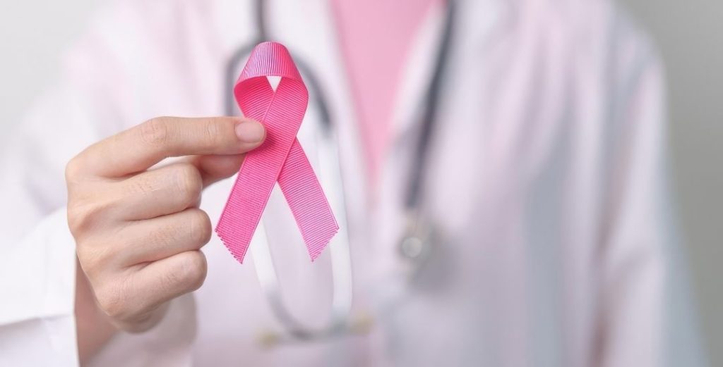 doctor holding pink breast cancer ribbon